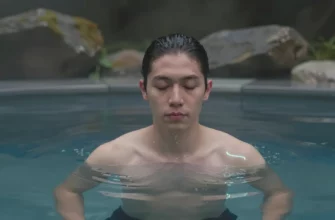 A person standing in a cold plunge pool surrounded by natural scenery, with a calm expression, water droplets, subtle glowing lines indicating a reset of the nervous system, no text or lettering