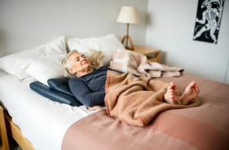A cozy bedroom scene featuring an older adult with arthritis comfortably resting on a weighted blanket, with a soft, supportive blanket draped over a bed, showing a sense of warmth and relief.