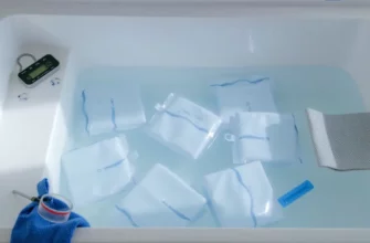 A photorealistic scene of a modern cold plunge setup: a clear, rectangular plunge tub filled with crystal‑clear water and large reusable ice packs floating inside. The tub is surrounded by a minimalist, white and blue aesthetic with subtle lighting that highlights the ice packs’ reflective surfaces. A small, sleek thermometer is placed on the side of the tub, and a pair of rubber gloves and a towel are casually draped nearby. The background is a calm, neutral space that emphasizes the cool, refreshing atmosphere of the plunge.