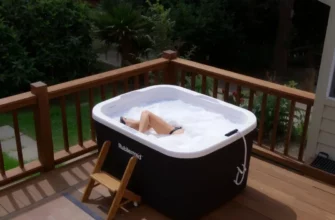 A Rubbermaid cold plunge tub filled with icy water, set on a wooden deck in a backyard, surrounded by lush greenery and a small wooden ladder, with a person in swimwear stepping into the tub, all rendered in a realistic style