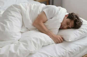 A person lying on a bed with a weighted blanket, looking uncomfortable or struggling, the blanket appearing heavy and slightly tangled, no text or symbols