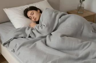 A serene bedroom scene featuring a person peacefully sleeping under a large, textured weighted blanket with subtle geometric patterns, soft ambient lighting, and a calm atmosphere emphasizing deep relaxation