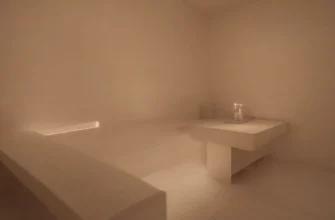 A serene and minimalist depiction of a modern sauna interior with a person relaxing on a wooden bench. Soft, warm lighting illuminates the scene, highlighting the natural wood textures. A glass door reveals a glimpse of a cold plunge pool with shimmering water. Focus on tranquility and wellness.