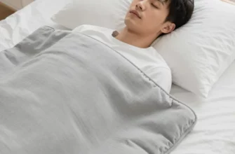 A child (around 5 years old) comfortably sleeping with a weighted blanket on a bed in a brightly lit bedroom. The child appears peaceful and relaxed. Focus on the child's face and the blanket's texture.
