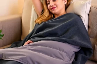A person comfortably using a 48x72 weighted blanket while relaxing on a couch. The blanket should be neatly folded and draped over the person's lap. Soft, warm lighting in the room.