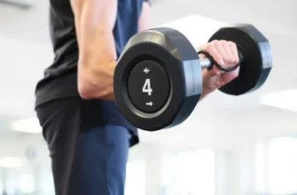 A person lifting a 4-pound weight, demonstrating proper form. The background is a clean, brightly lit gym setting. Focus on the muscles being engaged during the lift.
