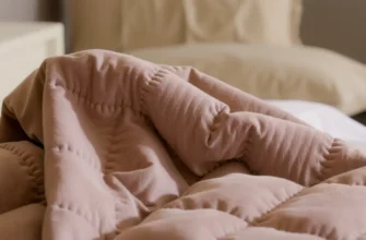 A close-up, photorealistic image of a high-quality weighted blanket with intricate stitching and a soft, plush texture. The blanket should be draped over a comfortable bed with a neutral-colored duvet and pillows. Focus on the details of the blanket's weave and the weight distribution.
