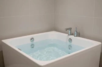 A sleek modern bathroom featuring a cold plunge tub filled with clear icy water, surrounded by minimalist tiles and soft ambient lighting, emphasizing relaxation and wellness