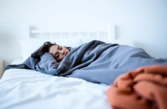A serene bedroom scene showing a person relaxing under a weighted blanket, with soft lighting and calm colors, emphasizing comfort and wellness