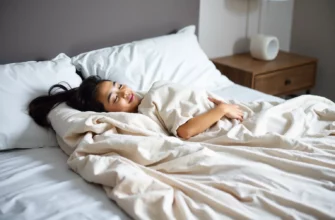 A serene bedroom scene featuring a person peacefully resting under a soft, neutral-toned sensory weighted blanket, with gentle ambient lighting and subtle textures emphasizing calm and relaxation