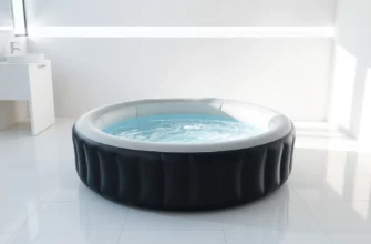 A professional product photograph showing a modern inflatable cold plunge tub filled with clear water, placed in a sleek contemporary bathroom setting with minimalist design elements, soft natural lighting highlighting the tub's texture and water surface, clean white tiles and subtle steam effects to convey cold temperature, no people visible, high detail on water ripples and tub material