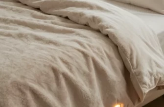 A cozy bedroom scene featuring a plush, textured weighted blanket with visible heating elements subtly integrated, draped over a comfortable bed with soft pillows and warm lighting, emphasizing comfort and modern technology