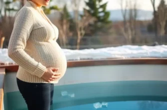 A pregnant woman standing near a cold plunge pool, looking thoughtful and cautious. The pool is filled with clear, cold water, and there are ice cubes floating on the surface. The woman is dressed in comfortable, warm clothing suitable for a cold environment. The background shows a serene outdoor setting with trees and a clear sky, emphasizing a natural and peaceful atmosphere.