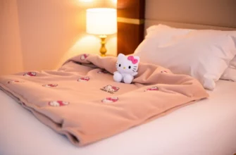 A cozy bedroom scene featuring a plush weighted blanket with a subtle Hello Kitty pattern draped over a neatly made bed, soft ambient lighting, and a small Hello Kitty plush toy placed on the pillow, emphasizing comfort and tranquility