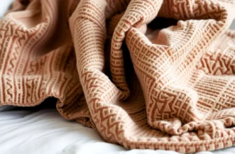 A close-up of a luxurious, textured weighted blanket in muted earth tones draped over a cozy bed, with subtle mosaic tile patterns visible in the fabric weave, soft natural lighting highlighting the fabric's depth and tactile quality
