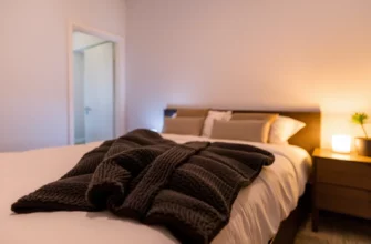 A cozy bedroom scene featuring a neatly made bed with a plush weighted blanket draped over it, soft ambient lighting, and a relaxed atmosphere, emphasizing comfort and tranquility